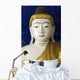 Head of a Buddha statue against blue background Wall Mural