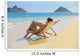 Beautiful woman lounges on a remote beach Wall Mural