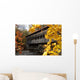 A covered bridge over a river in Autumn Wall Mural
