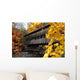 A covered bridge over a river in Autumn Wall Mural