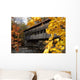 A covered bridge over a river in Autumn Wall Mural