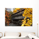 A covered bridge over a river in Autumn Wall Mural