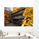 A covered bridge over a river in Autumn Wall Mural