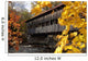 A covered bridge over a river in Autumn Wall Mural