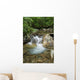 A rocky riverbed and waterfall Wall Mural