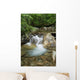 A rocky riverbed and waterfall Wall Mural