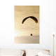 Paraglider flying in front of vibrant sunset EDITORIAL USE ONLY Wall Mural