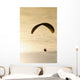 Paraglider flying in front of vibrant sunset EDITORIAL USE ONLY Wall Mural
