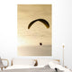 Paraglider flying in front of vibrant sunset EDITORIAL USE ONLY Wall Mural