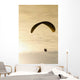 Paraglider flying in front of vibrant sunset EDITORIAL USE ONLY Wall Mural