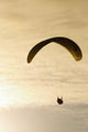 Paraglider flying in front of vibrant sunset EDITORIAL USE ONLY Wall Mural