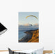 Paraglider flying over ocean cliffs at sunset EDITORIAL USE ONLY Wall Mural