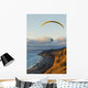 Paraglider flying over ocean cliffs at sunset EDITORIAL USE ONLY Wall Mural