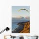 Paraglider flying over ocean cliffs at sunset EDITORIAL USE ONLY Wall Mural