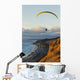 Paraglider flying over ocean cliffs at sunset EDITORIAL USE ONLY Wall Mural