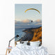 Paraglider flying over ocean cliffs at sunset EDITORIAL USE ONLY Wall Mural