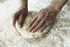 Close-Up Of Hands Kneading Dough Wall Mural