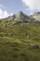 Scenic Of High Rugged Mountain Peaks And Green Tundra Hillside Wall Mural
