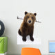 Captive Brown Bear Sitting In Snow Wall Mural