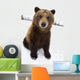 Captive Brown Bear Sitting In Snow Wall Mural