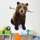 Captive Brown Bear Sitting In Snow Wall Mural