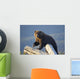 A Captive Brown Bear Stands On A Log Pile Wall Mural