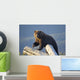 A Captive Brown Bear Stands On A Log Pile Wall Mural