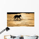 Silhouetted Archipelago Wolf Trotting Across Snow Field Wall Mural