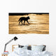 Silhouetted Archipelago Wolf Trotting Across Snow Field Wall Mural
