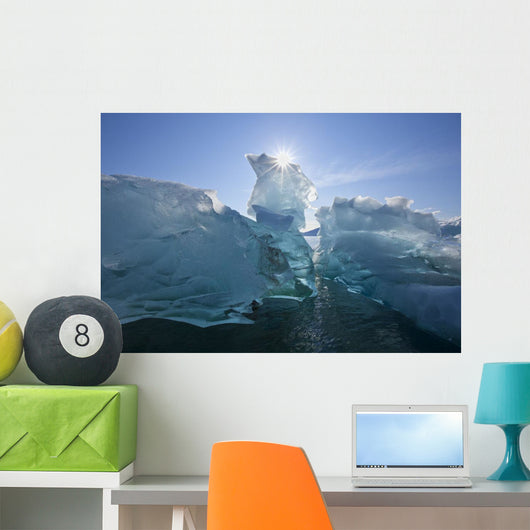 An Iceberg Floating On The Calm Waters Of Holkham Bay Wall Mural