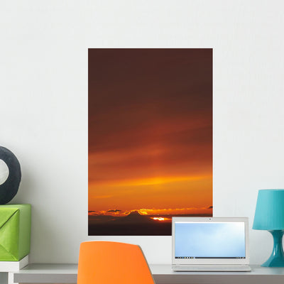 Augustine Volcano Silhouetted Sunset Wall Decal shown on a wall