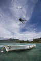 kiter's jump over a boat Wall Mural