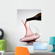 pouring red wine into decanter Wall Mural
