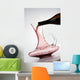pouring red wine into decanter Wall Mural
