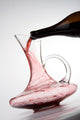 pouring red wine into decanter Wall Mural