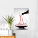 pouring red wine into decanter Wall Mural