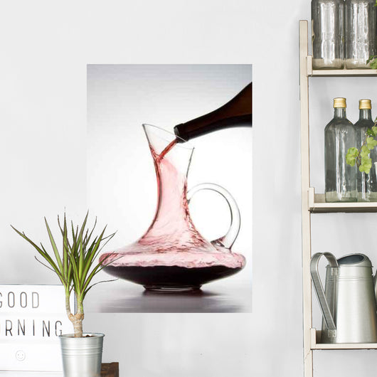 pouring red wine into decanter Wall Mural