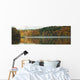 Autumn Coloured Trees Along The Shoreline Of A Lake Wall Mural