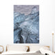 A close-up view of glacial ice strewn across a coastal beach Wall Mural