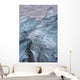A close-up view of glacial ice strewn across a coastal beach Wall Mural