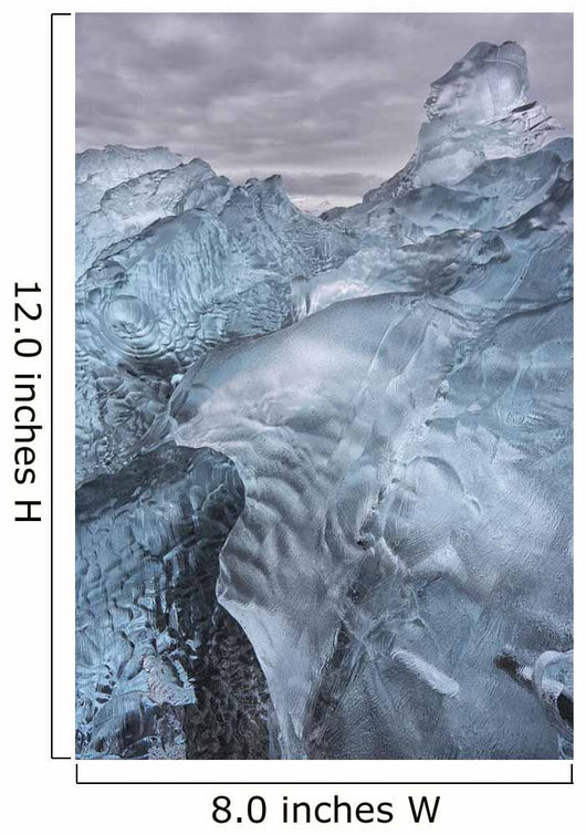 A close-up view of glacial ice strewn across a coastal beach Wall Mural