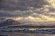 Shafts of sunlight shine on the ice calves floating Wall Mural