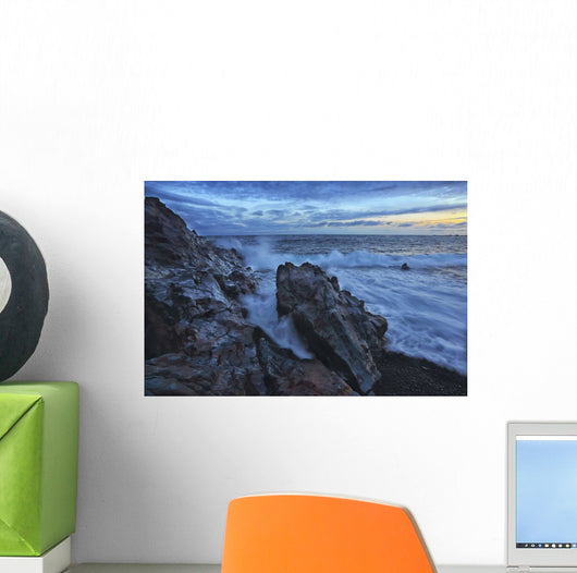 Waves crash over the shoreline along the beach of djupalonssandur Wall Mural