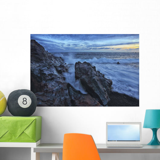 Waves crash over the shoreline along the beach of djupalonssandur Wall Mural