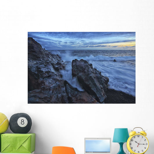 Waves crash over the shoreline along the beach of djupalonssandur Wall Mural