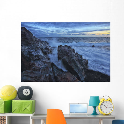 Waves crash over the shoreline along the beach of djupalonssandur Wall Mural