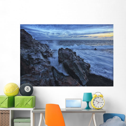 Waves crash over the shoreline along the beach of djupalonssandur Wall Mural