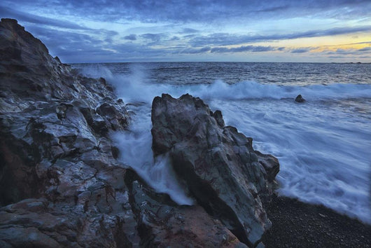 Waves crash over the shoreline along the beach of djupalonssandur Wall Mural