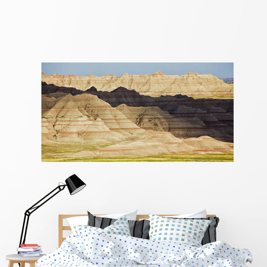 Light and shadows paint the landscape of badlands national park Wall Mural