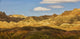 Dramatic light on the eroded formations of badlands national park Wall Mural